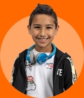 Young boy on an orange background, smiling to the camera.